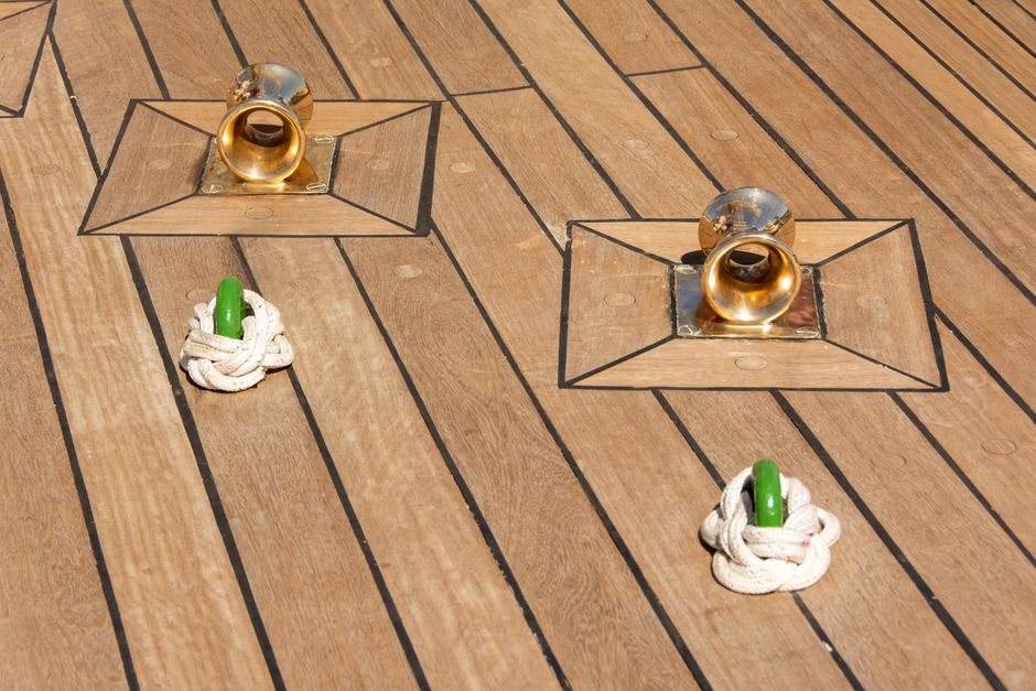 Brass deck fittings set into a teak boat deck