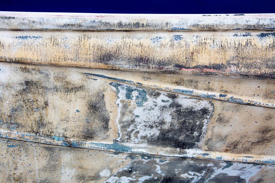 Weathered wooden boat hull before restoration