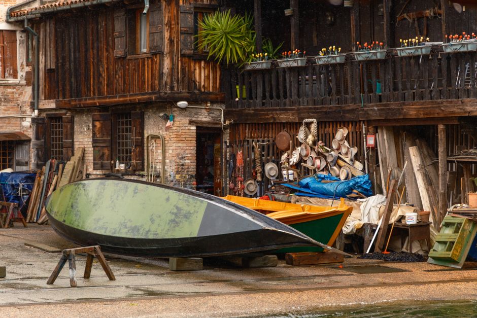 Traditional wooden boat workshop with boats under restoration